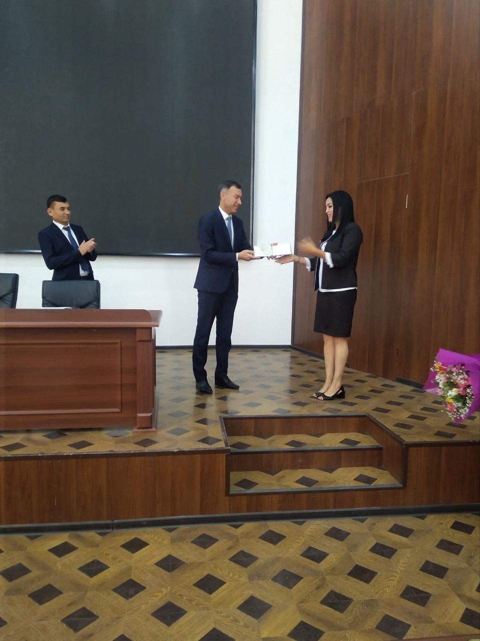 The process of awarding the title of PhD and Associate Professor by Professor Ilhomjon Tukhtasinov.
